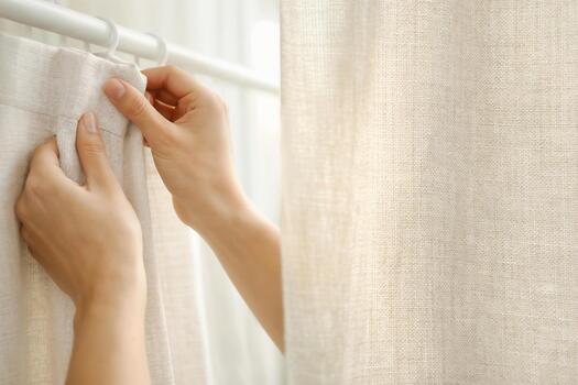 Clean linen curtains hanging in a bright room